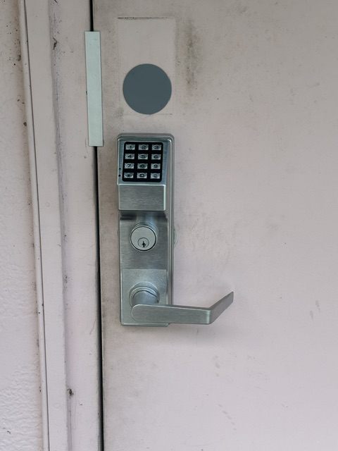 Commercial keypad lock installed on a business entry door in Broward County