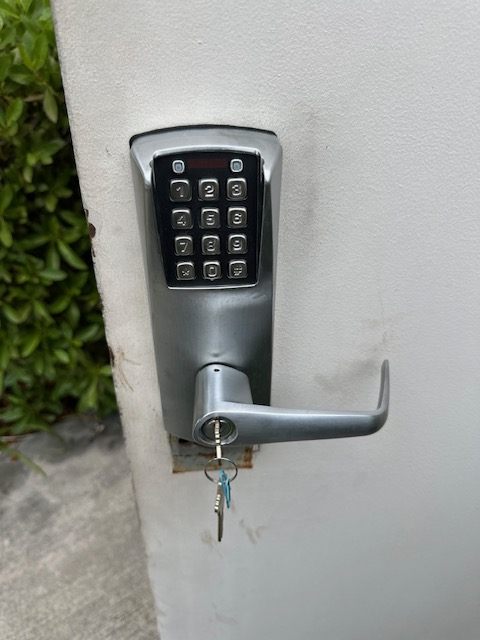 Keypad lever lock on an exterior gate with keys left in the cylinder after programming