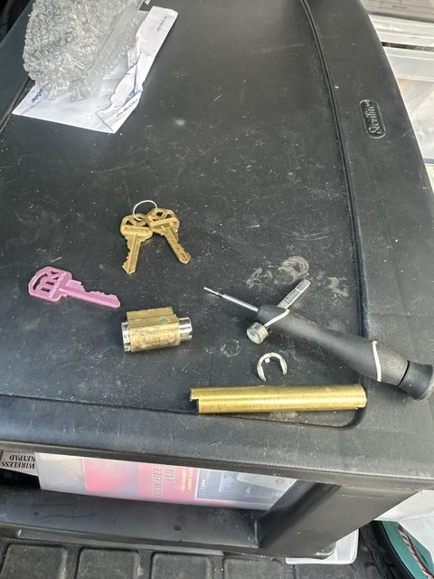 Locksmith re-pinning a lock cylinder during a rekey in Broward County
